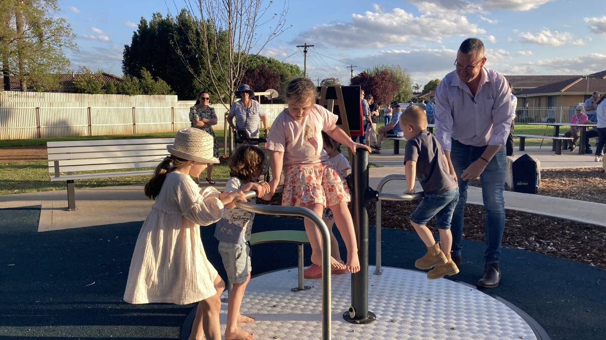 Mayor Doug Curran, hard at work spinning the carousel for the youngest constituents. Picture by Cai Holroyd