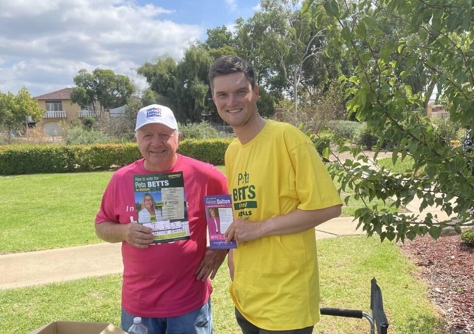Helen Dalton campaign volunteer Louis Toscan and Victorian-based young Nationals vice-president James Brook say they will persist at Yoogali Public School despite voting have slowed. Picture Allan Wilson