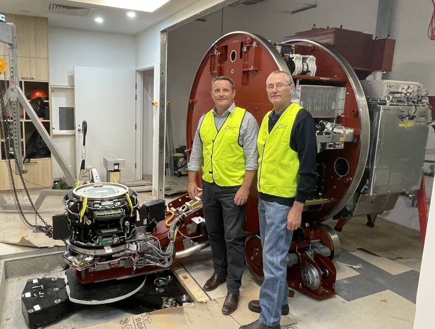 Cancer Care Associates chief operating officer, Damien Williams and Griffith Cancer Care's consumer representative, Grant Hearn, with the machine on Monday. Photo Allan Wilson.