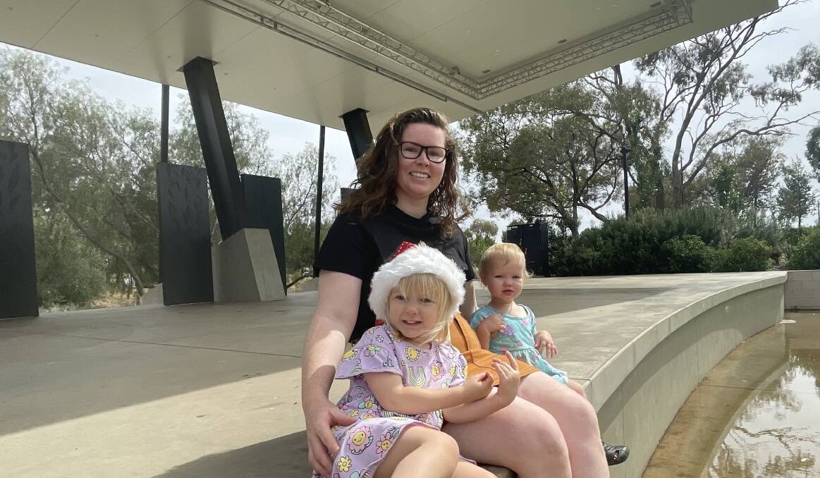 Creative Director of this years Carols by Candlelight Danielle Pfitzner pictured at the Memorial Gardens stage with daughters Olivia and Eloise. Picture by Allan Wilson