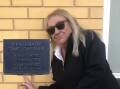 Organiser Angela Masters points out the time capsule plaque established in the 1980s. Picture supplied.
