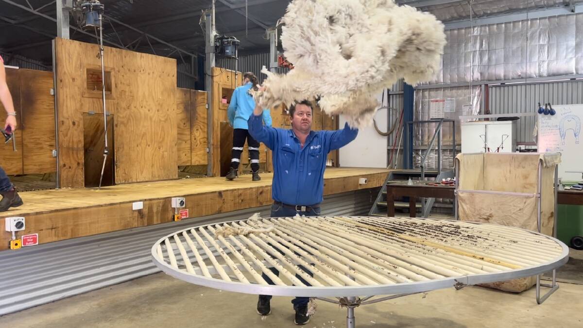Andrew Baxter from the TAFE NSW Primary Industries Centre sorts through the wool following a demonstration as part of the TAFE NSW Shearing School initiative. Picture by Taylor Dodge