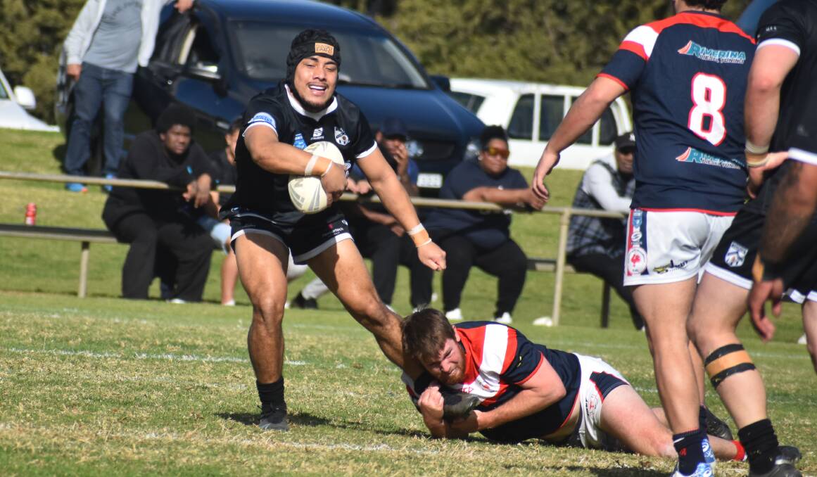Black and Whites' Solo Toru looks to escape the grasp of DPC Roosters' Luke Hogan when the two sides met in round 14. Picture by Liam Warren