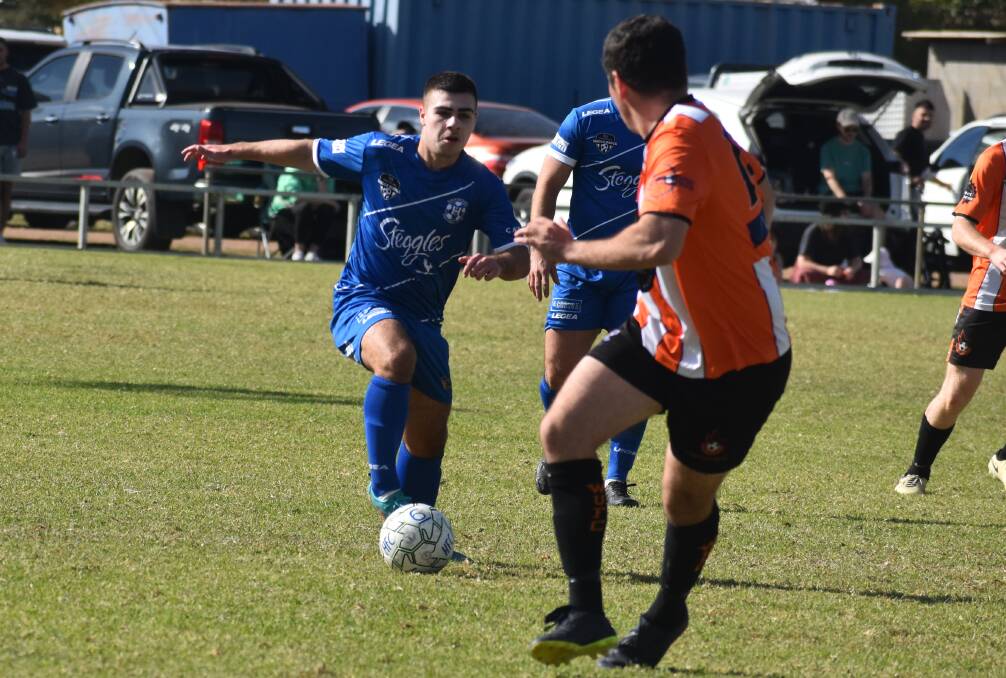 Sebastian Patane carries the ball forward as Hanwood open their Pascoe Cup defence with a win at home against Wagga United. Picture by Liam Warren