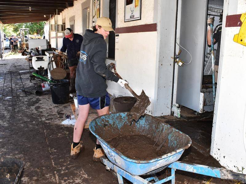 Residents stoically clean up but fear their town will be forgotten in the aftermath of the floods. (Murray McCloskey/AAP PHOTOS)